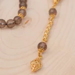 ⁦سبحة حجر كوارتز كريستال مع شرابات ذهبية⁩ - الصورة ⁦2⁩